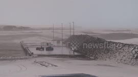 Huge waves and stormy sea in Husavik, Iceland, with waves roaring in over the dock