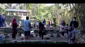 A Muslim families gather during a tradition Sadranan or Nyadran at a cemetery in Yogyakarta on April 9, 2021, to offer prayers on the last Friday before the start of the holy fasting month of Ramadan