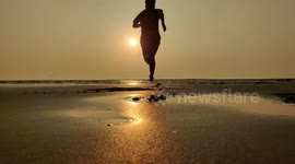 Slow motion Running at the beach during the sun set. The sun was so gloomy.