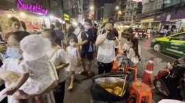 Trumpet player uses face mask with hole in it to play to passers-by in Thailand