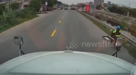 Truck nearly-misses cyclist who suddenly crosses road in Vietnam