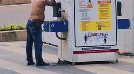 Funny Action of a Man Bathing in Public Facilities on the Side of Jalan Raya Sudirman, Central Jakarta, Indonesia