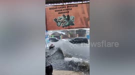 Two cars make giant wave on flooded road in Indonesia