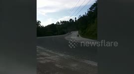 Motorcycle rider crashes while doing a stunt on a bend in the Philippines