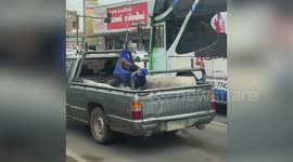 Man spotted travelling in hammock attached to pickup truck in Thailand