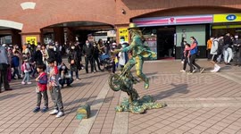 Levitating man stands on motorbike and perform on street in Dan Shui, Taiwan.