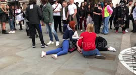 Piccadilly Circus, London - 17th April 2021: Woman COLLAPSES whilst dancing to the YMCA at a street party in Piccadilly Circus amid the coronavirus pandemic