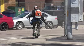 Spring cleaning in the university district of Waterloo Canada using a unicycle and leaf blower for maximum efficiency to clean parking lot