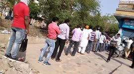 People queue in front of wine shops in huge number after lockdown is announced in the Indian capital Delhi amidst surging cases of coronavirus