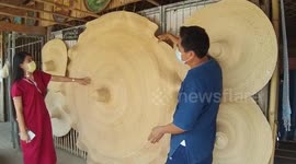 Two-metre wide straw sun hats proving popular during hot summer season in Thailand