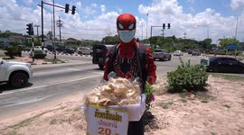 Food seller wears Spider-Man costume to sell roadside snacks