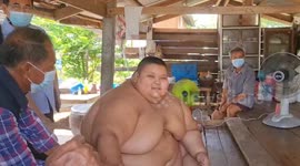 Health workers battle to help 32 stone obese boy, 13, in Thailand