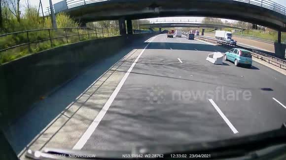 Have a seat: Sofa dropped on Manchester motorway leaves UK drivers baffled