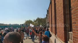 Ominous motorcyclist entertains lively antilockdown protestors along embankment