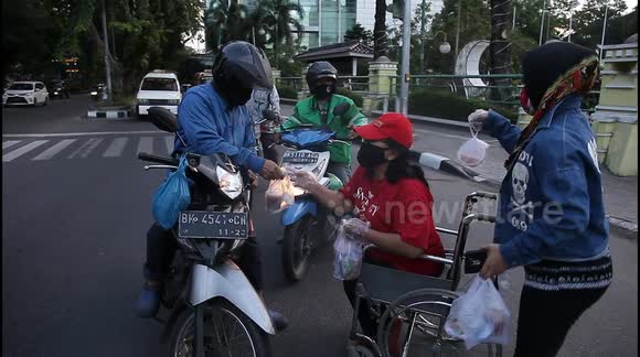 Muslims in Indonesia distribute food during the holy month of Ramadan