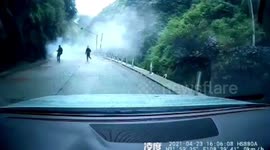 Father and son narrowly escape being buried by rocks tumbling down mountain in China