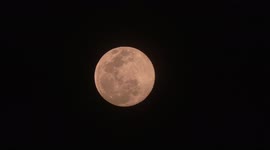 A Pink Super Moon high in the sky over Chiang Mai in Thailand
