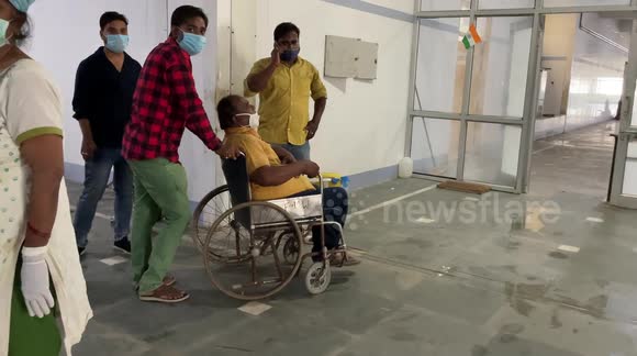 COVID patients wait for treatment & stretcher trolley in North India Government Hospital