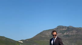 Stylish businessman wearing a suit rides his WAKEBOARD home from work