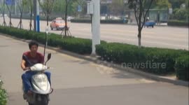 Man rides scooter while attached to IV drip