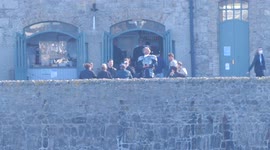 House of Dragon costumed actors take a break. armed knights drink coffee on the terrace at St Michaels mount island Mounts Bay Cornwall UK