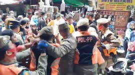 Civil service police officers clash with clothing traders at Tanah Abang Market, Central Jakarta, Indonesia