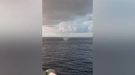 Waterspout forms near sailors in the South China Sea