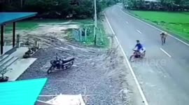 Terrified motorcycle rider tries to escape angry cow running on road