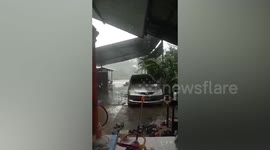 Terrifying moment tree falls on woman's car in Thailand during severe storm