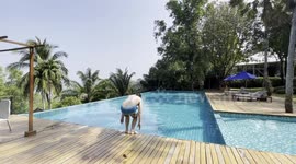 Man topples backwards making amusingly graceless entry into swimming pool