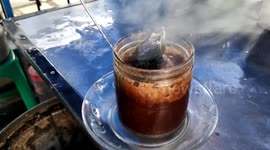 Trying hot charcoal coffee in Yogyakarta, Indonesia