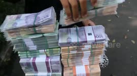 Jakarta money sellers struggle as demand drops amid travel ban