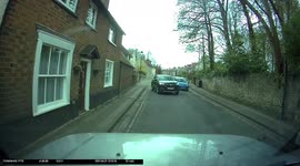 Driver screeches onto pavement during village street overtake