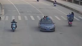 Mother fined after allowing her children to lean out of sunroof of moving car in China