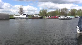 Norfolk Broads holiday-hire motor cruiser arrives at Beccles, Suffolk UK, and reverses to the quay, 12 May 2021
