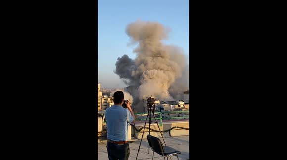 Watch moment fearless photographer calmly snaps shots as missile attack destroys al-Sharouk Tower in Gaza