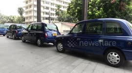 London style cabs collect shoppers in Bangkok, Thailand