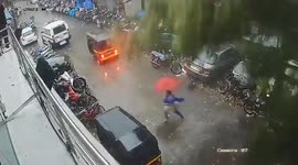 Woman dodges falling tree during cyclone Taukte in Mumbai, India