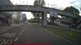 Two men cross the road when the car waiting drives at them to run them over.