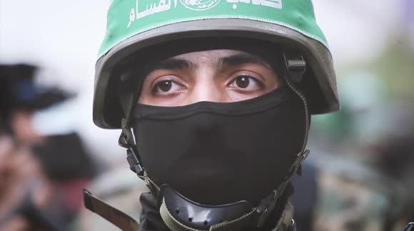 Members of Hamas' military wing march to mark end of hostilities