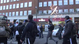Protester lights firework on Kensington High St during pro-Palestine march in London