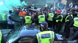 Pro-Palestine protesters in London damage a car as police rush in to protect the vehicle