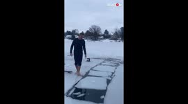 Two guys play risky game of 'ice hopscotch' on frozen lake in Michigan