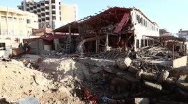 Palestinians enjoy their time in a cafe damaged by Israeli airstrike