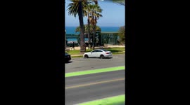 Video shows 100’s and 100’s of motorcyclist cruising down Ocean Avenue in Santa Monica, California. People waved and cheer as they went by with police escorts from a half dozen police forces escorted them. Shot Vertically.