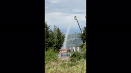Fre fighters use aerial platform to dampen scene of fire within Units of Victorian mill  in Bradford, UK