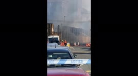 Hosing down fire within Units of old Victorian mill following  fire in Bradford, UK