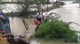 Man carries cylinder while evacuating village in eastern India