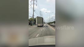 Truck’s container doors swing open dangerously on road