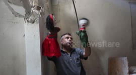 Palestinians inspect the Art House Center destroyed by Israeli missile strikes
